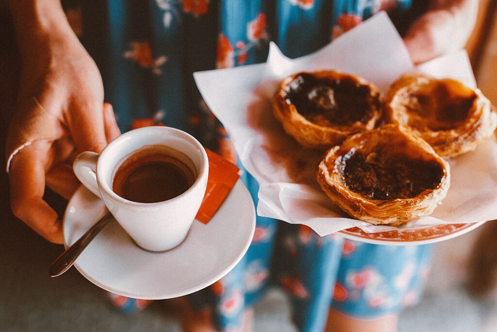 famous Portugeue custard tarts with a cup of espresso a treat that is very much a part of Portuguese culture and cuisine.