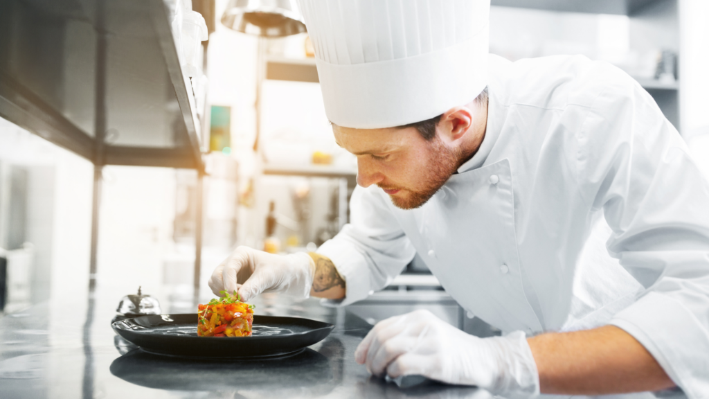 chef prepares a dish of vegetables which is a sought after dish in a Michelin-starred restaurants in Lisbon