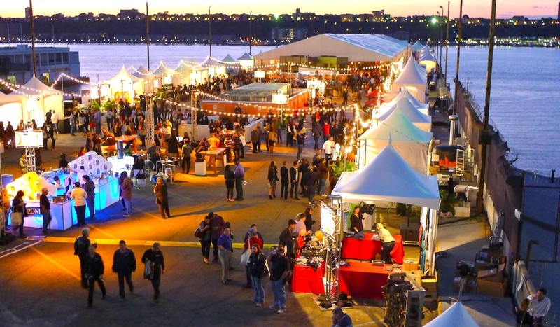 Crowd enjoying food festival on New York pier with chef tasting tents – vibrant foodie travel event in America